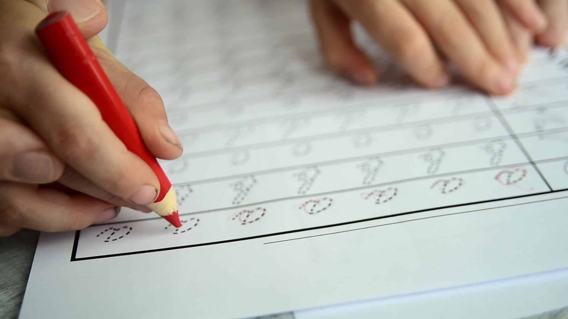 Father teaching child to write letters