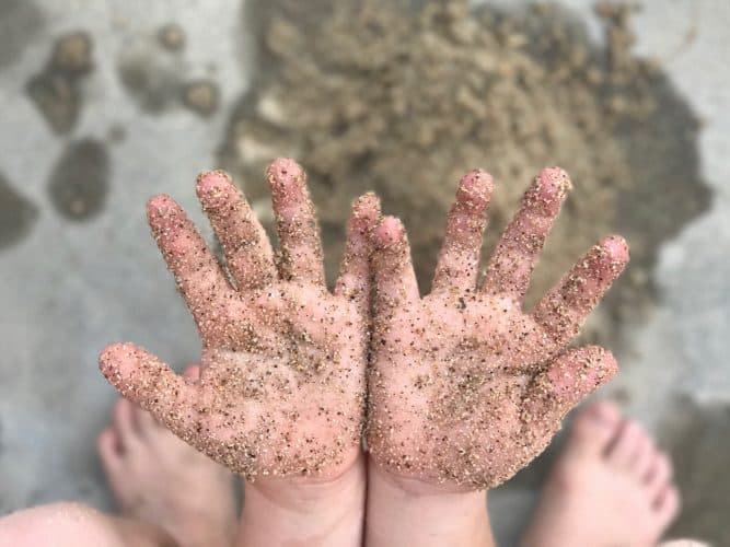 Sensory play, boy playing with sand