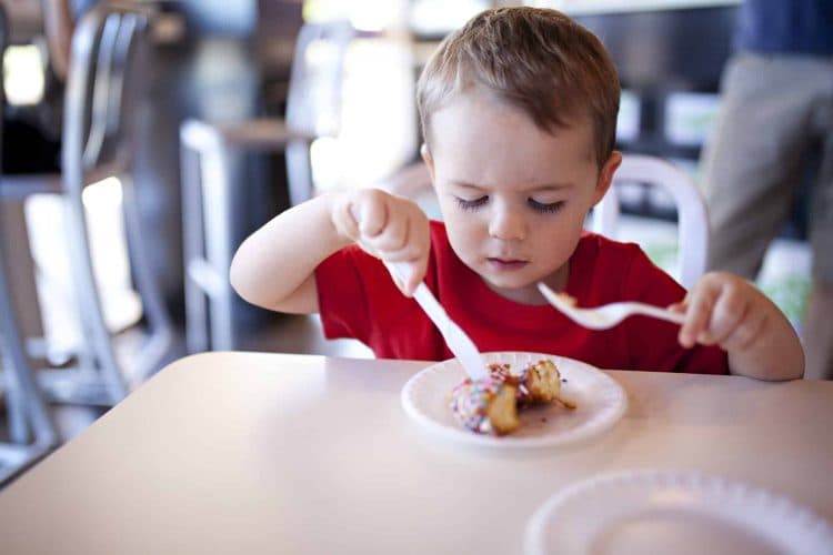 kids eating doughnuts while out on a family outing