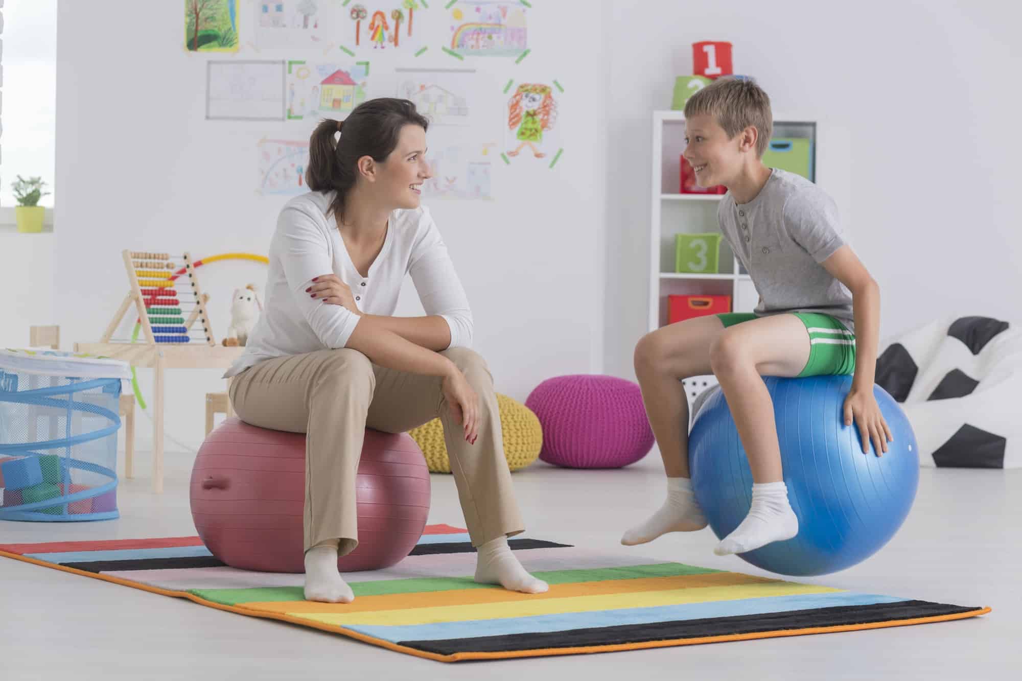 Boy sitting on gym ball