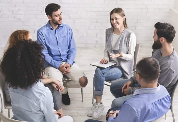 Psychotherapist talking with patients of support group
