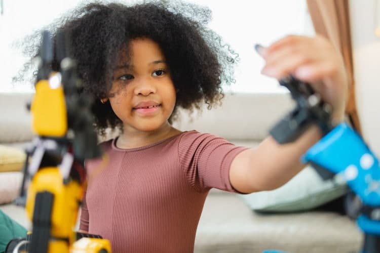 African Americans students learn robotic arms with a program computer at home