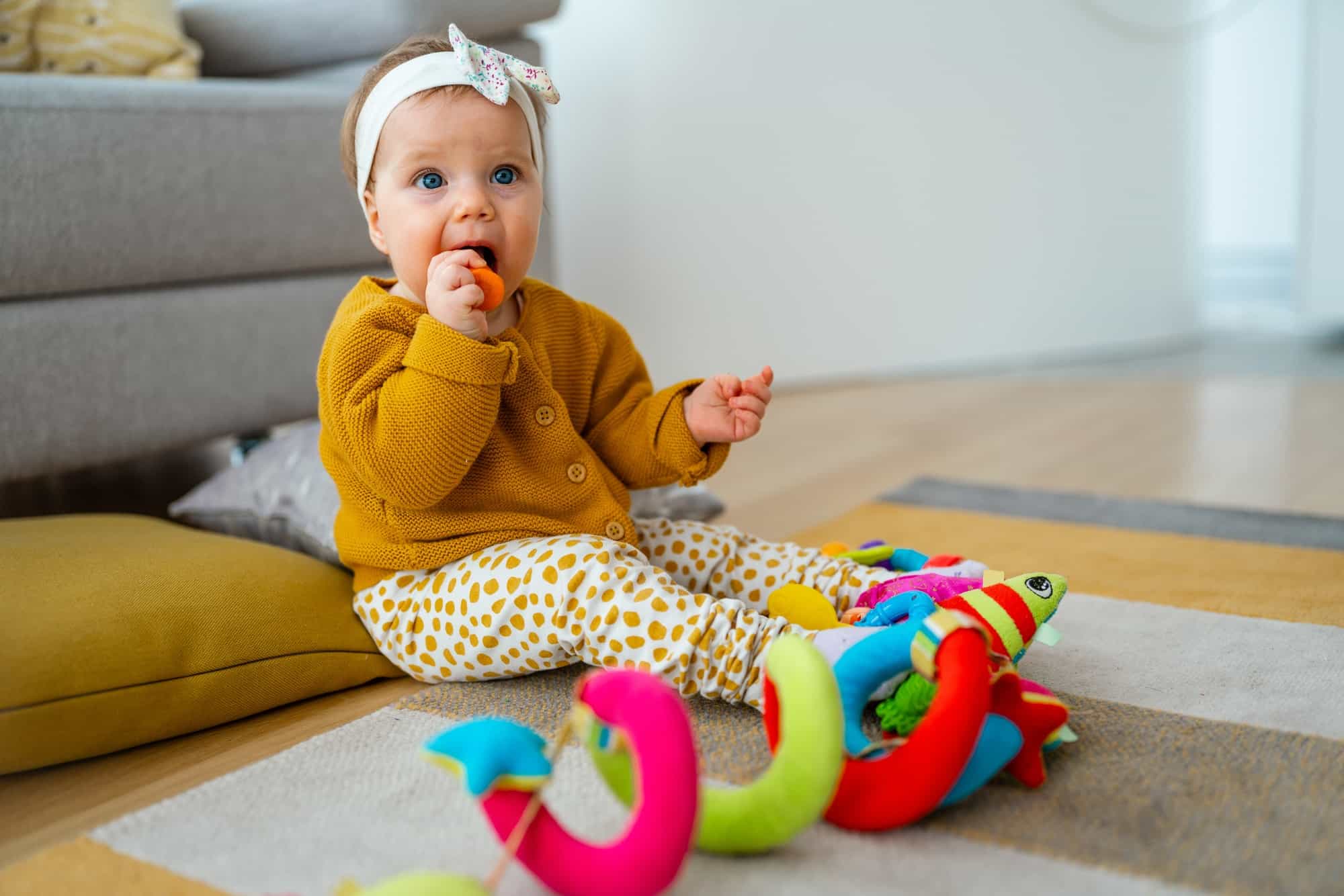 Adorable baby playing with colorful toy at home