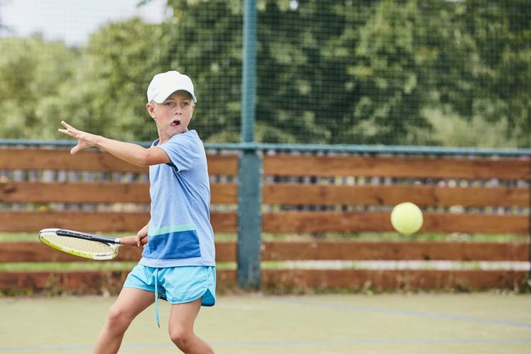 Little boy playing tennis