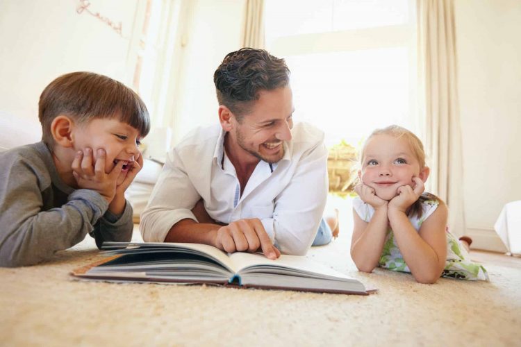 Father with two kids reading a story book.