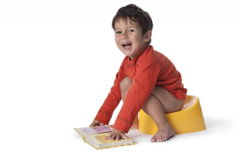 Toddler boy sitting on a potty
