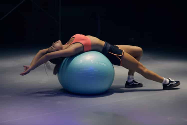 woman doing yoga on stability ball