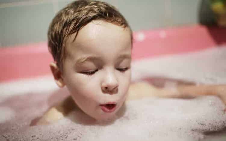 Little boy enjoying a foamy bubble bath