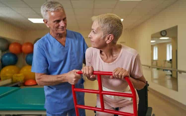 Occupational therapist working with mature woman in rehab center