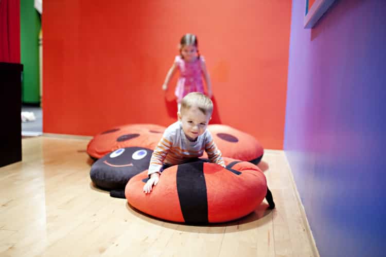 two kids jumping on bean bags