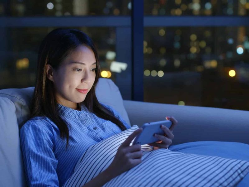 Woman watch video on cellphone at night